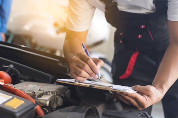 Mechanic performing servicing checks on a car